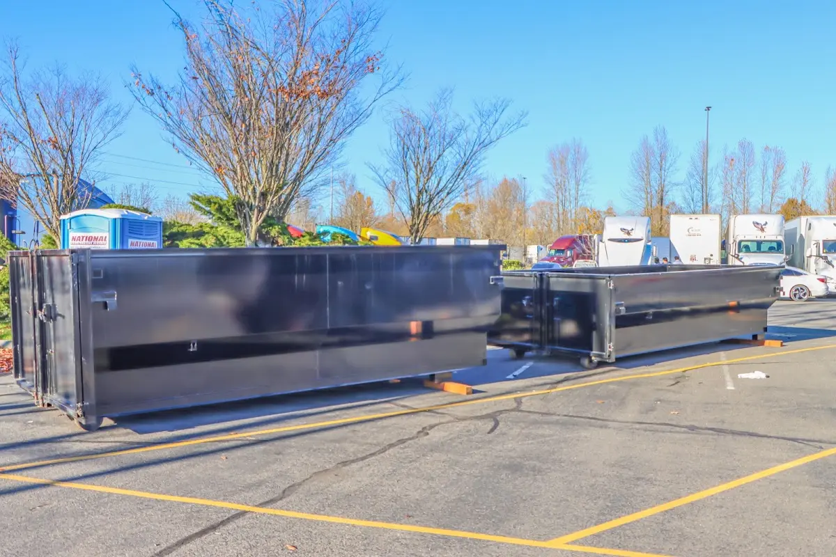 Professional dumpster rental service with roll-off container on residential driveway in Dearborn